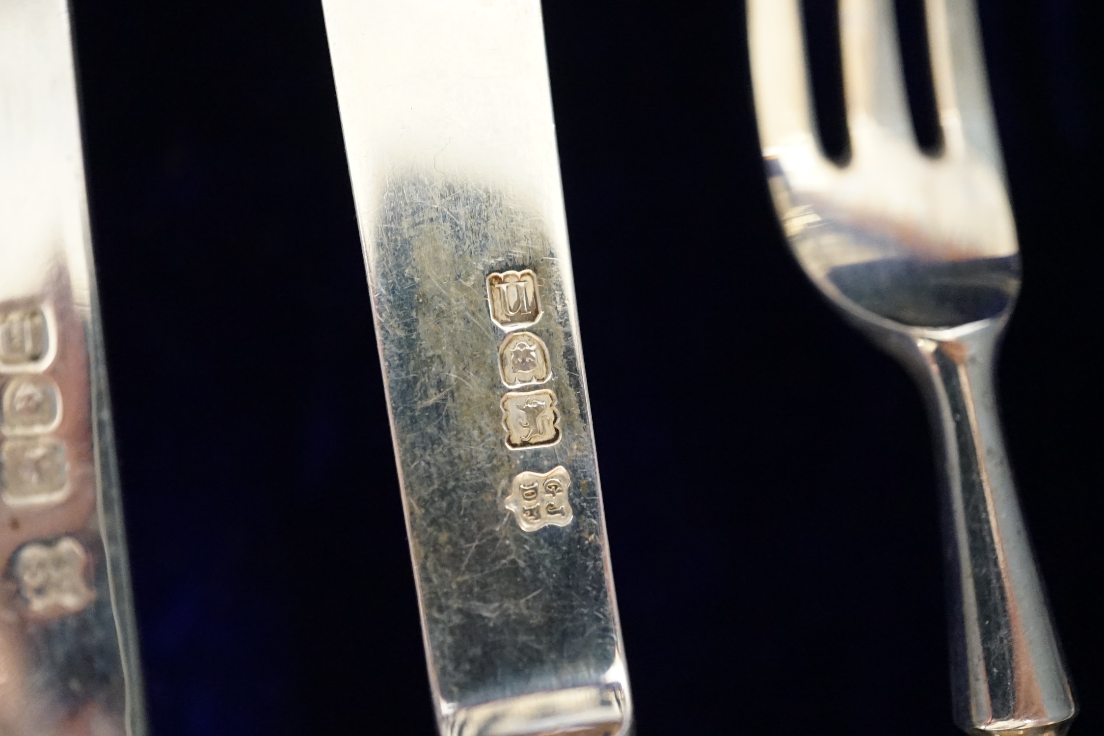 A cased set of twelve pairs of Edwardian silver and mother of pearl pistol handled dessert eaters, Josiah Williams & Co, London, 1908, knife 17.6cm.